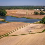 Aerial view of flat farm fields and a pond on a coastal plain like Virginia’s Eastern Shore