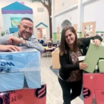 Nick and Amanda Rolon, the new owners of Creative World School in St. Cloud, smiling beside stacks of new soft play blocks inside the school